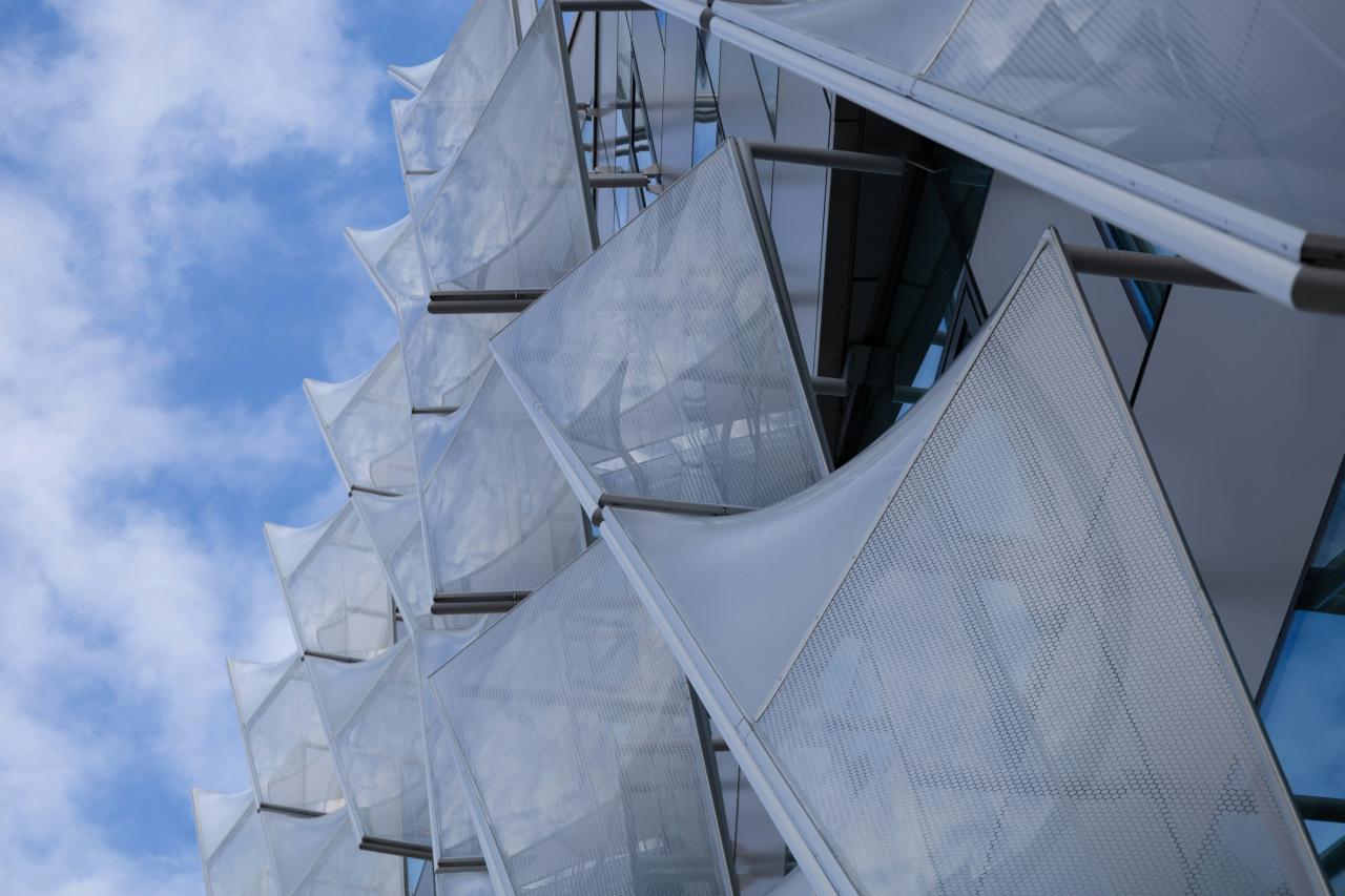 Modern building facade with white fabric screens